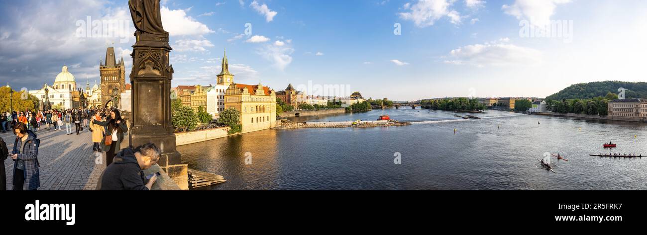 Prague, CZECH REPUBLIC - May 15th, 2023: The Moldau  / Vltava river in the middle of Prague, shot  from the Charles Bridge which is visible to the lef Stock Photo