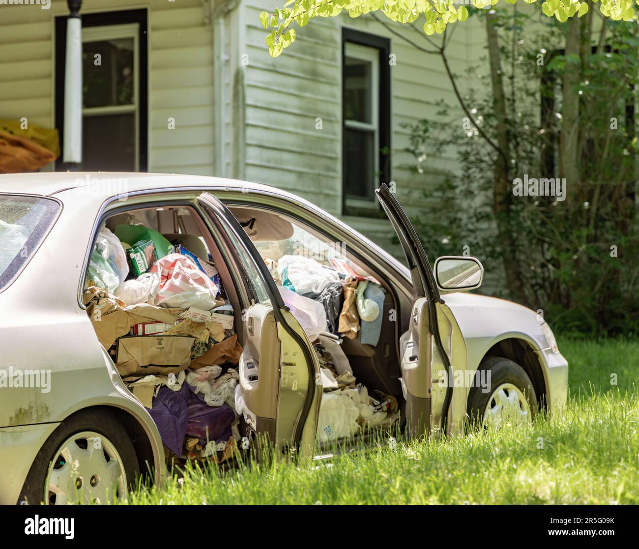 detail image of a four door vehicle full of trash Stock Photo