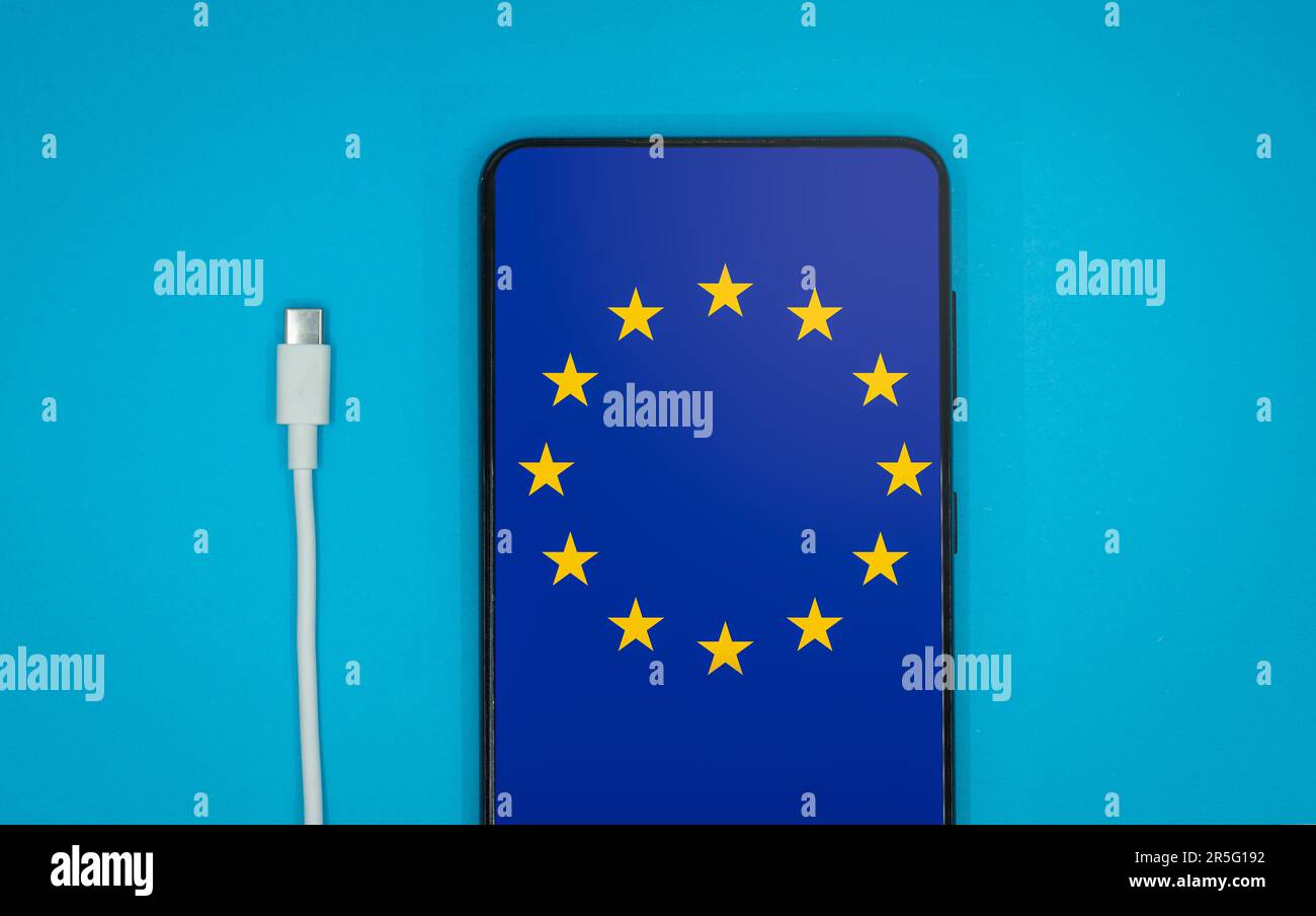 USB-C cable and a smartphone with the European Union Flag on screen Stock Photo