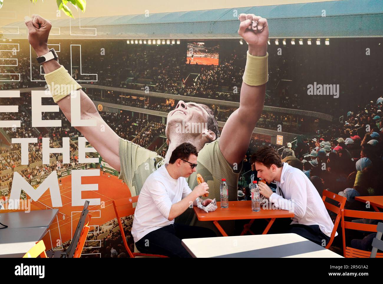 Paris, France. 03rd June, 2023. Visitors to the Roland Garros French Tennis Open share a bite to eat under a poster of tennis star Rafael Nadal of Spain in Paris, France, on Saturday, June 3, 2023. Photo by Maya Vidon-White/UPI Credit: UPI/Alamy Live News Stock Photo