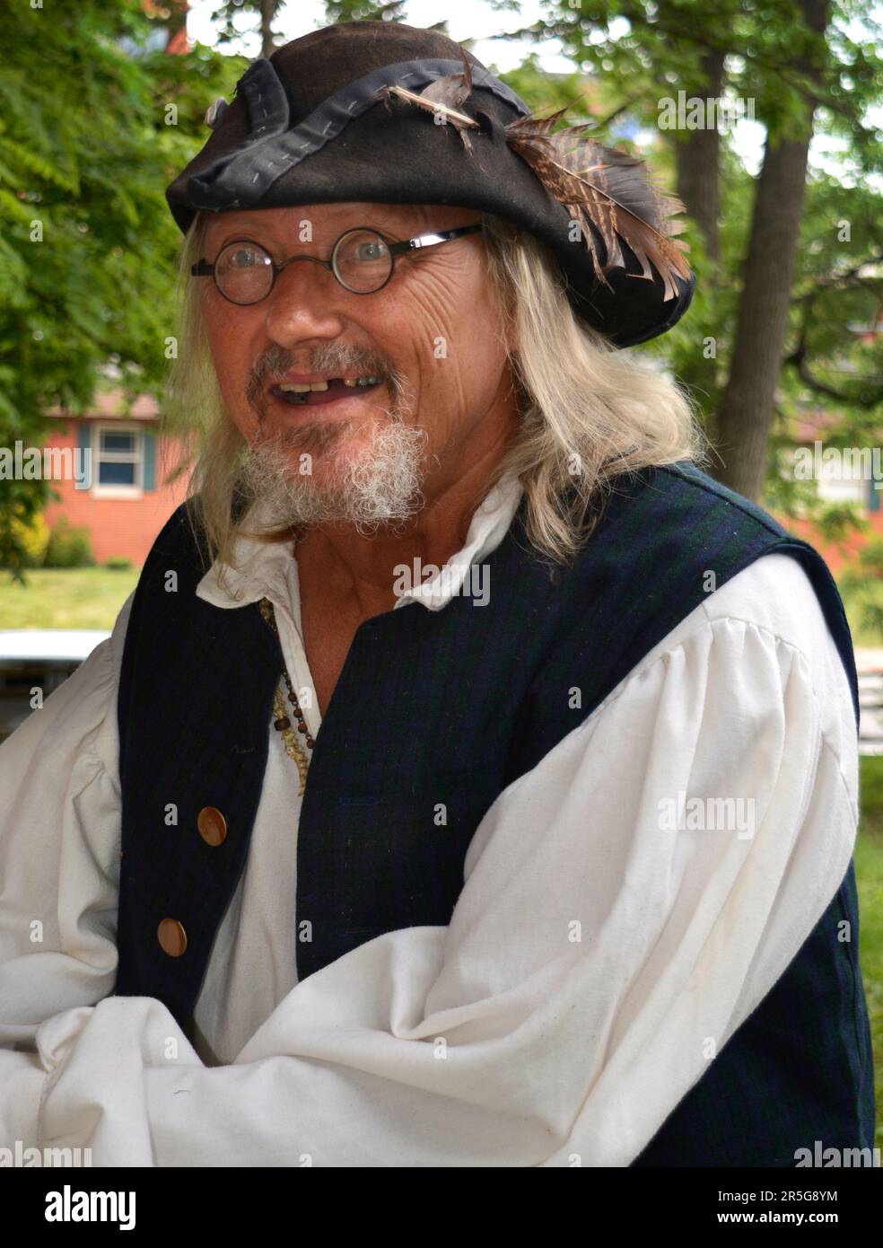 A history reenactor dressed in 19th centurystyle clothing speaks to
