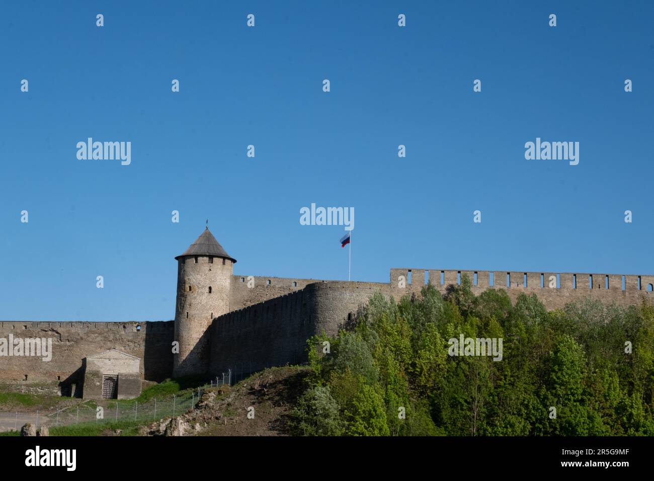 Ivangorod Fortress on the banks of the Narva River on a sunny May day. Stock Photo