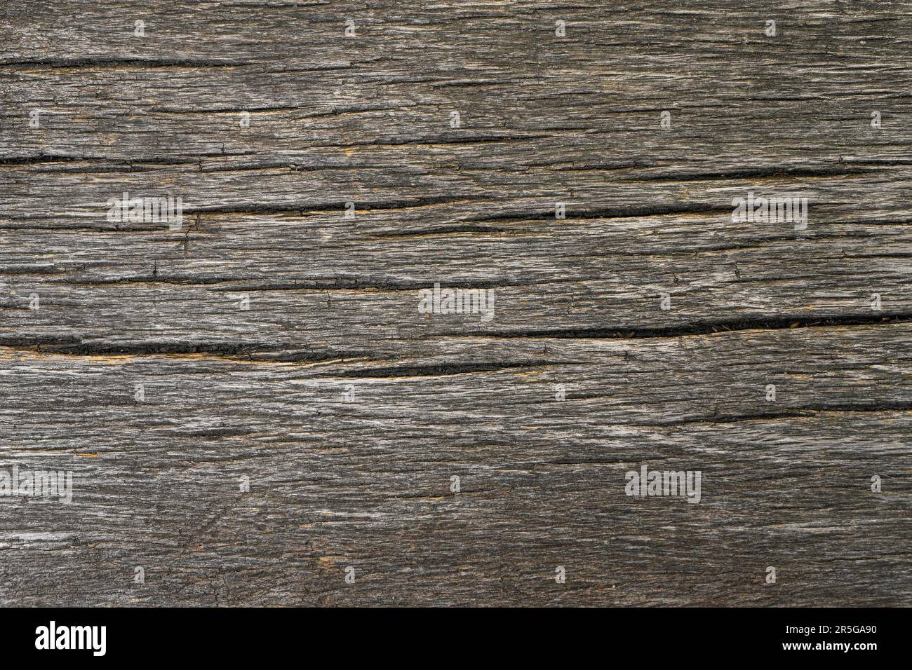 Old weathered wooden brown board structure with horizontal cracks. Close up natural grunge timber texture background, board floor, backdrop, wallpaper Stock Photo