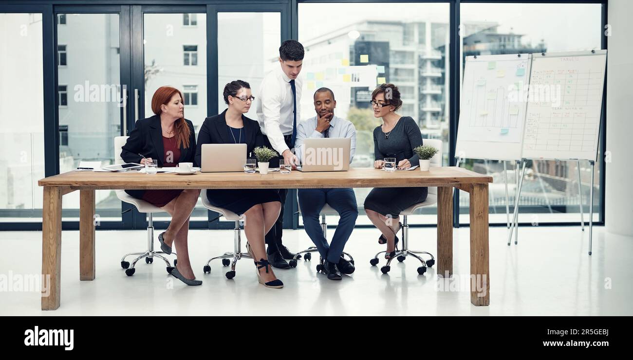 Sitting down with their problem-solving tools. group of businesspeople ...