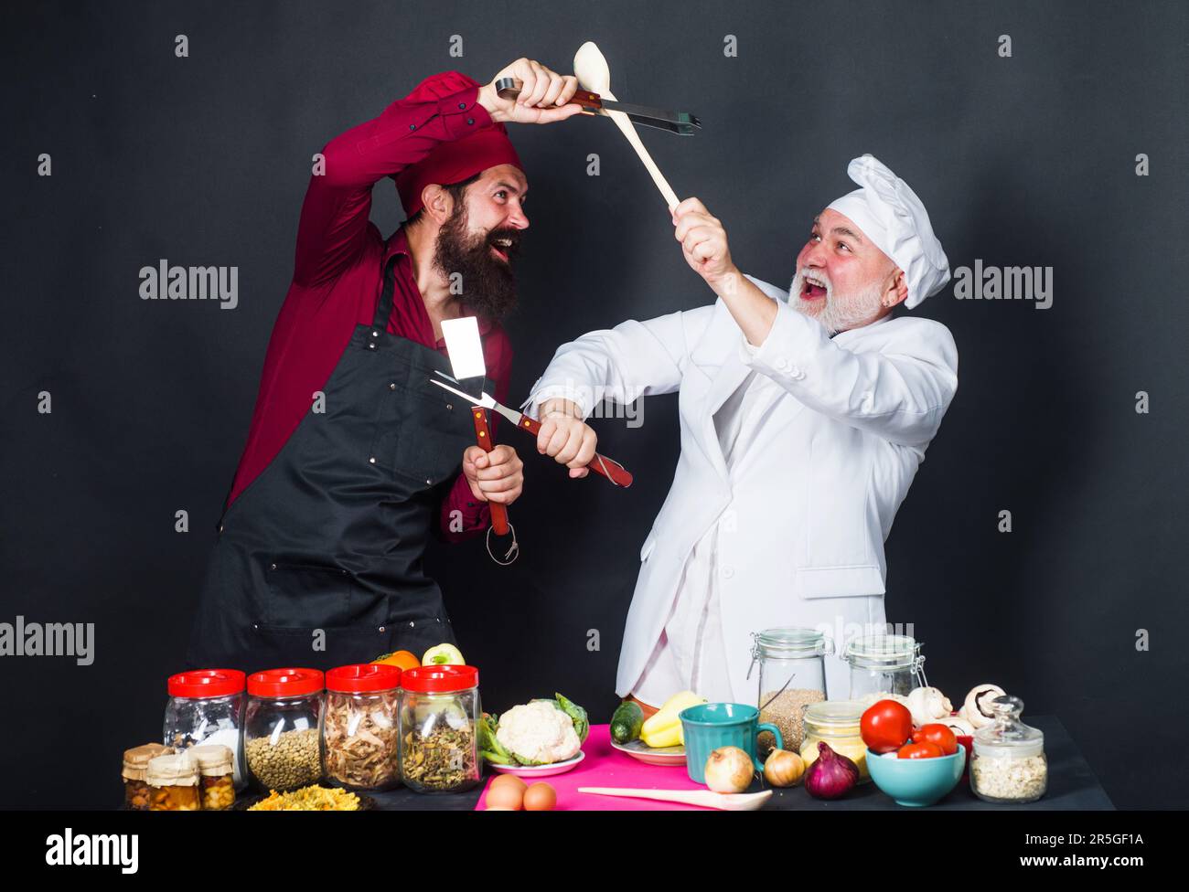 Culinary battle of professional chef. Two chefs in uniform on kitchen