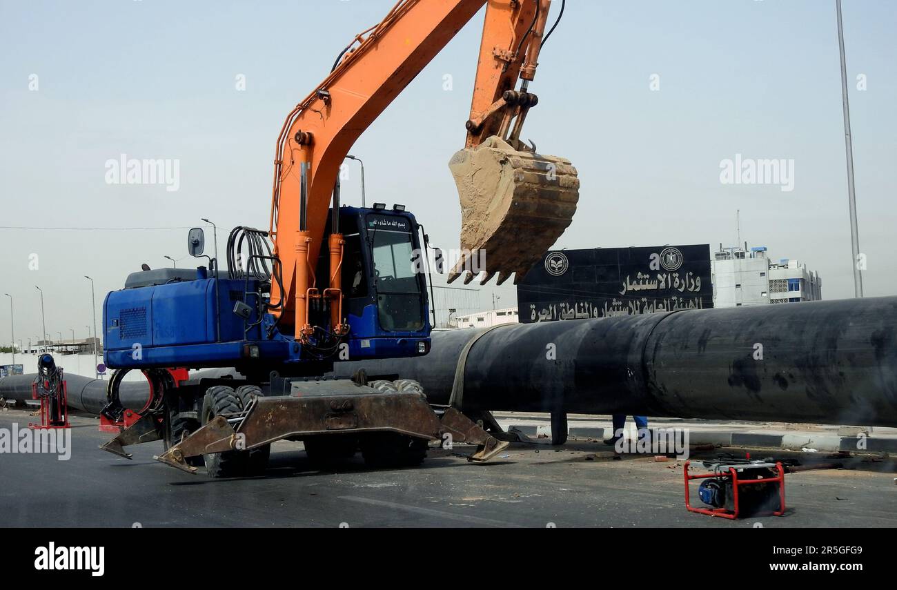 Cairo, Egypt, May 21 2023: preparations to place large water pipe parts in place, sanitation pipes, improvement of infrastructure and real estate deve Stock Photo
