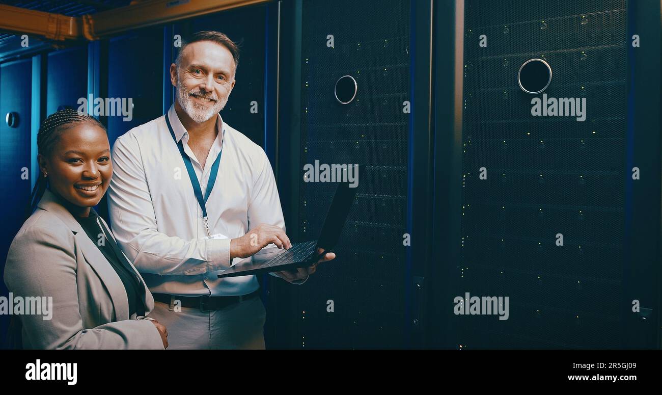 The programming pros are at it. Portrait of two technicians using a laptop while working in a server room. Stock Photo