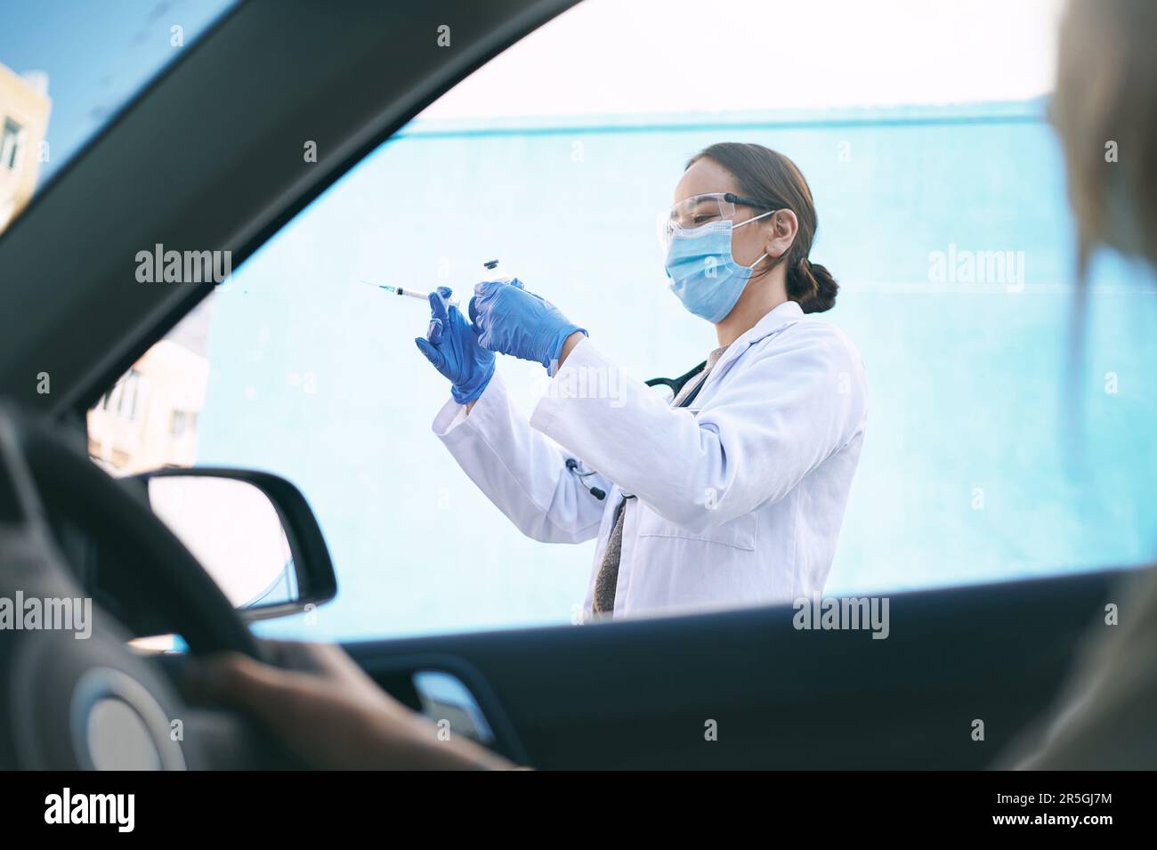 The time to take action is now. a masked young doctor giving a patient ...
