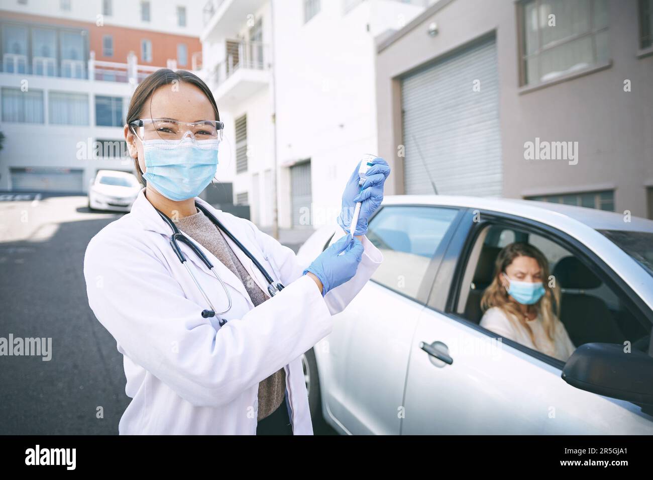 Good news, weve got the vaccine. a masked young doctor giving a patient ...
