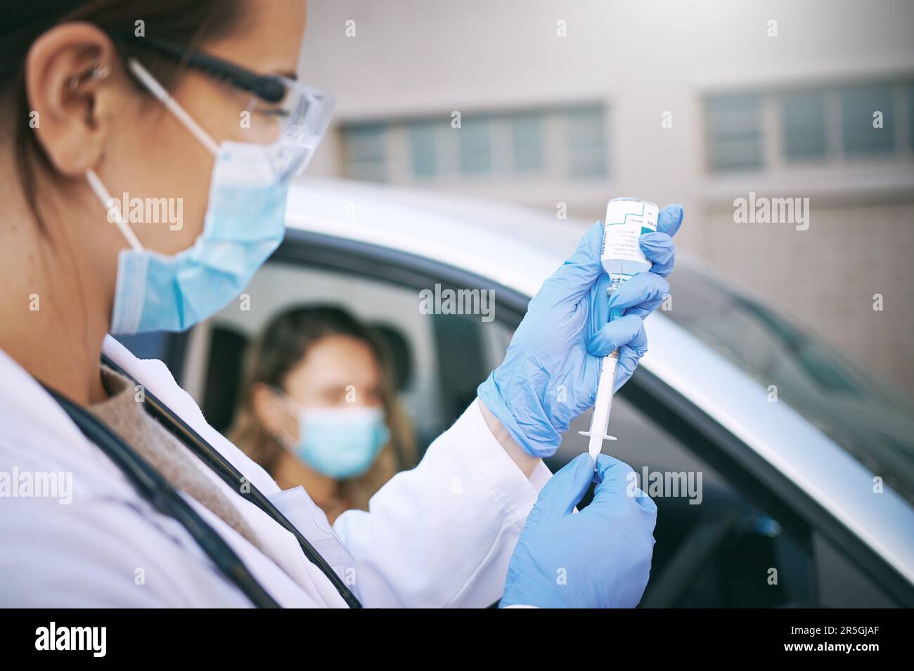 The beginning of the end of an outbreak. a masked young doctor giving a ...