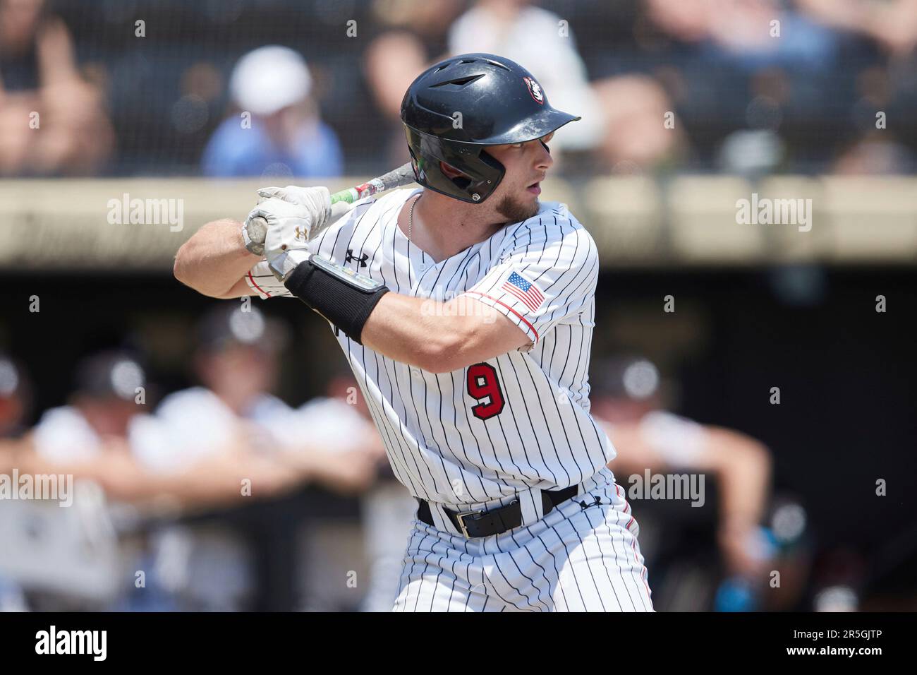 Harrison Feinberg (9) of the Northeastern Huskies at bat against the
