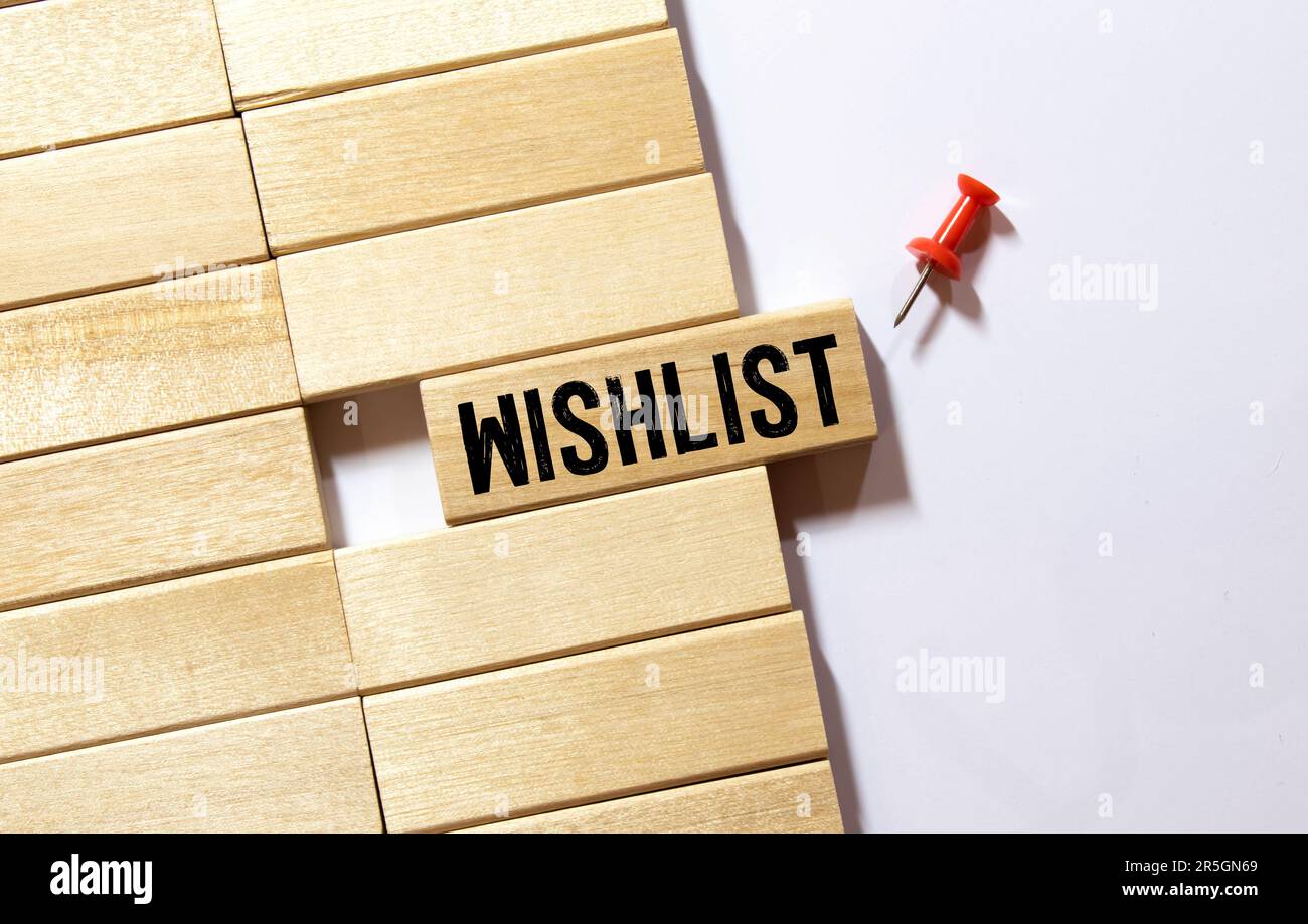 WISHLIST written text in small notebook on black background. Stock Photo