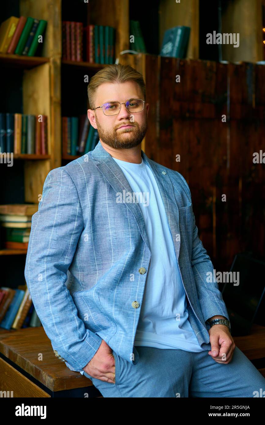 Guy in jacket sitting desk hi-res stock photography and images - Alamy