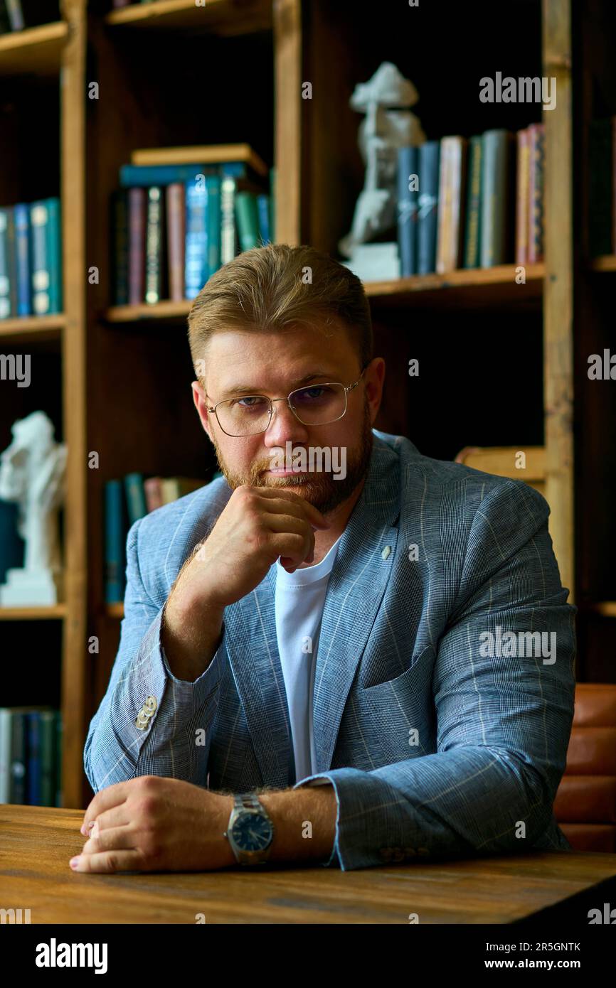 Guy in jacket sitting desk hi-res stock photography and images - Alamy