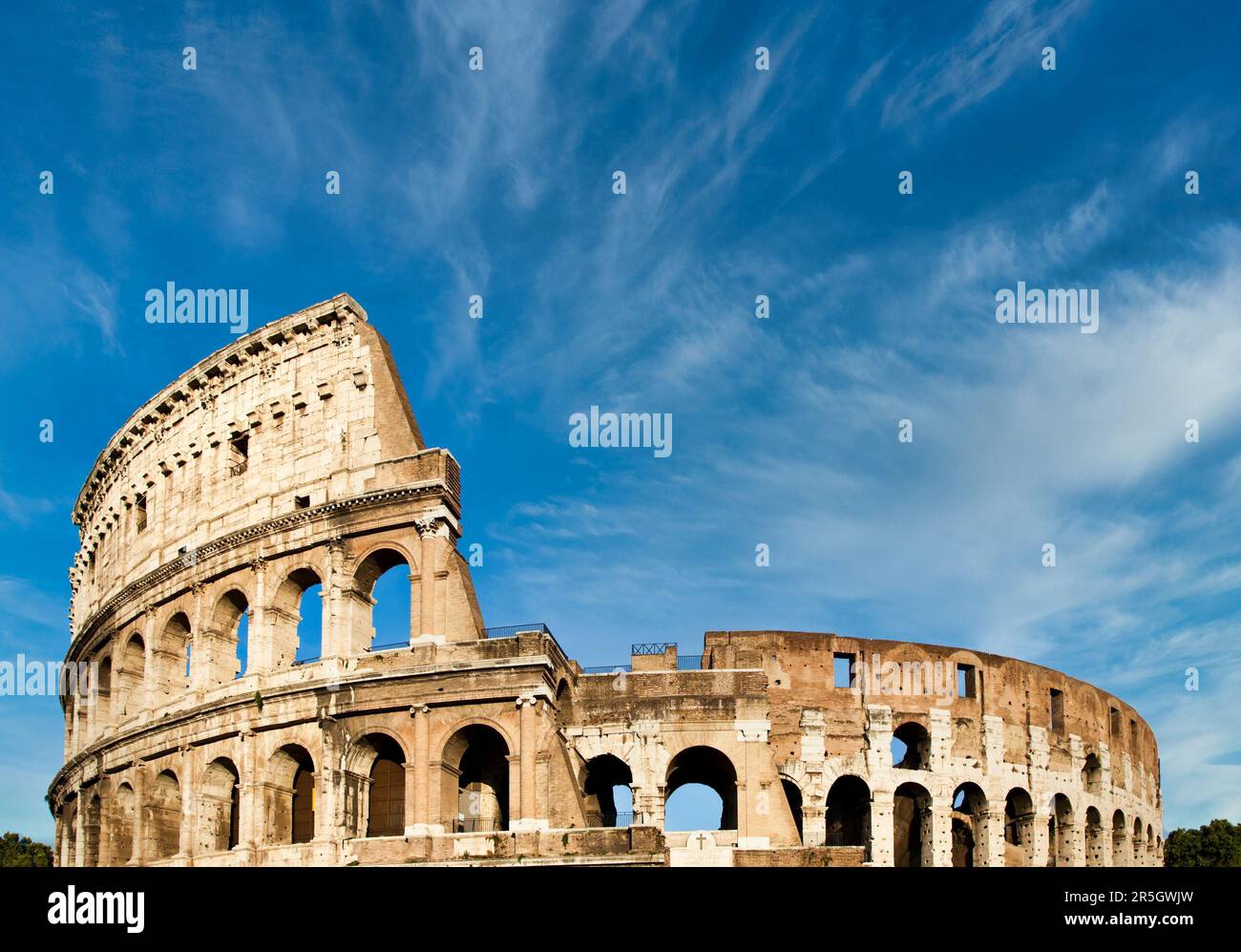 Rome, Italy. Arches archictecture of Colosseum (Colosseo) exterior with blue sky background and