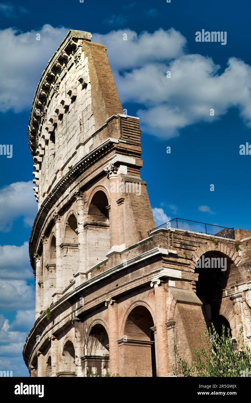Rome, Italy. Arches archictecture of Colosseum (Colosseo) exterior with blue sky background and