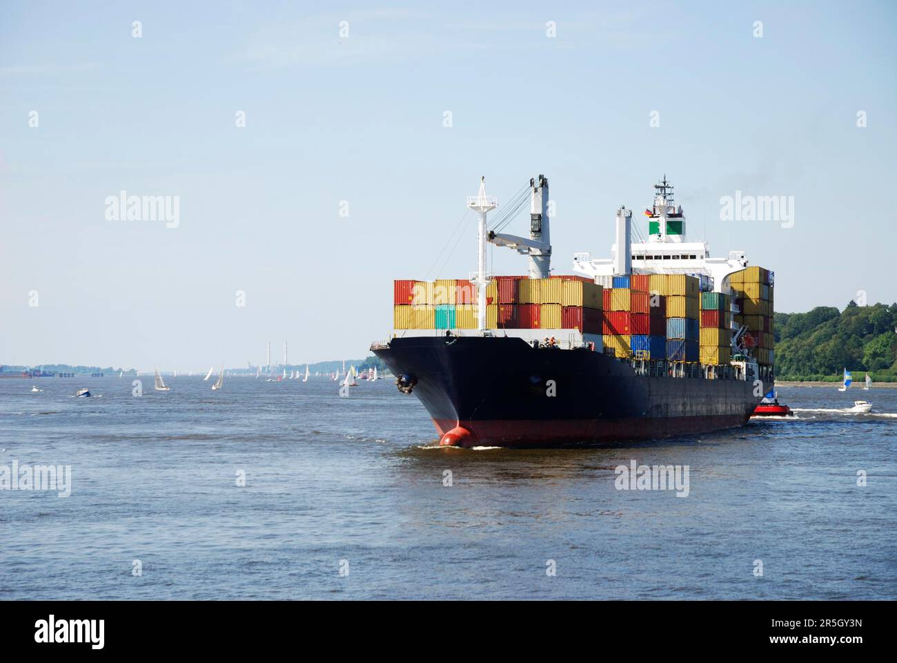 Container transport with a cargo ship Stock Photo - Alamy