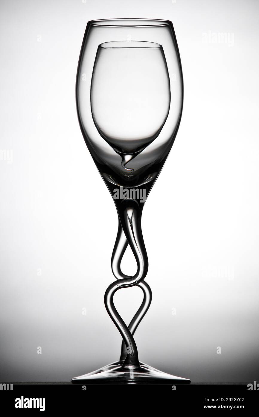 Curved double contrast wine glasses against a white background Stock