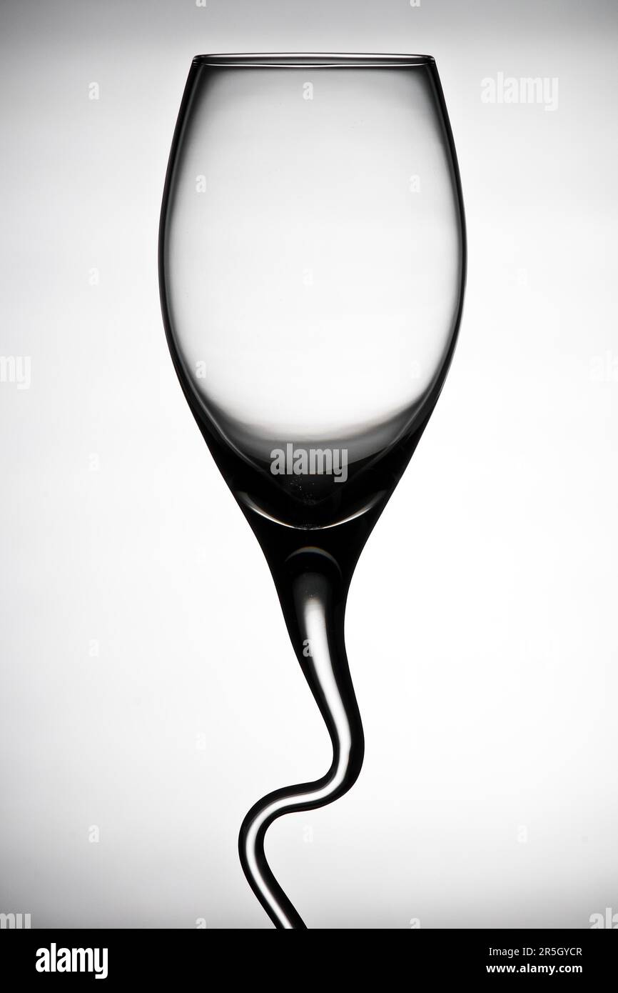Curved wine glass contrasting against a white background Stock Photo
