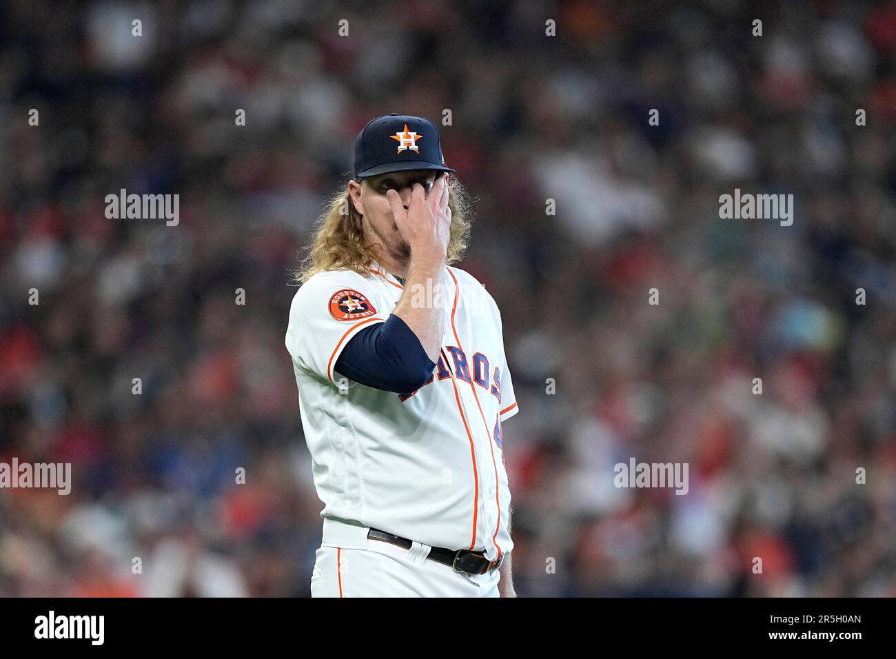 Houston Astros relief pitcher Ryne Stanek wipes his face after giving up a  home run to Los Angeles Angels' Hunter Renfroe during the seventh inning of  a baseball game Saturday, June 3