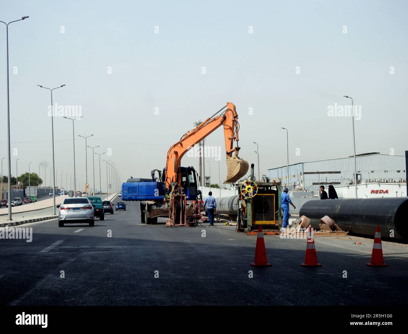 Cairo, Egypt, May 21 2023: preparations to place large water pipe parts in place, sanitation pipes, improvement of infrastructure and real estate deve Stock Photo