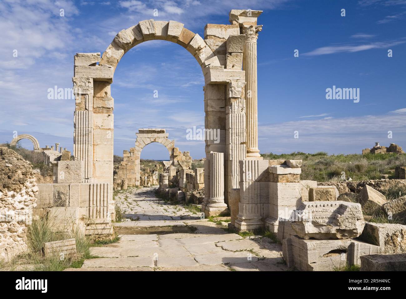 Arch of Trajan, in front of Arch of Tiberius, Via Trionfale, ruined city of Leptis Magna, Libya Stock Photo