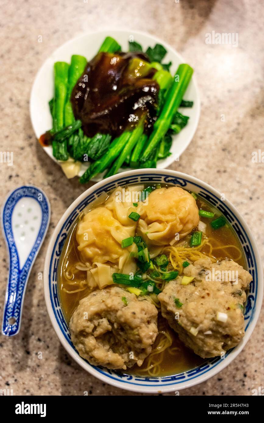 A Fish Ball and Wonton Noodle Dish and Steamed Vegetables At The Tsim