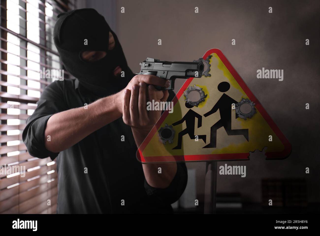 School shooting. Man in mask holding gun in classroom. Warning road sign Children with bullet holes Stock Photo