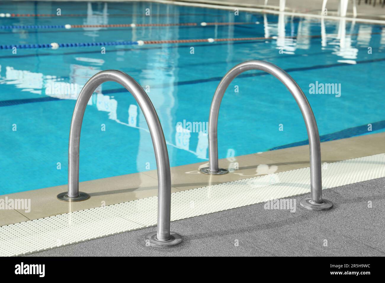 Ladder with handrails in outdoor swimming pool Stock Photo Alamy