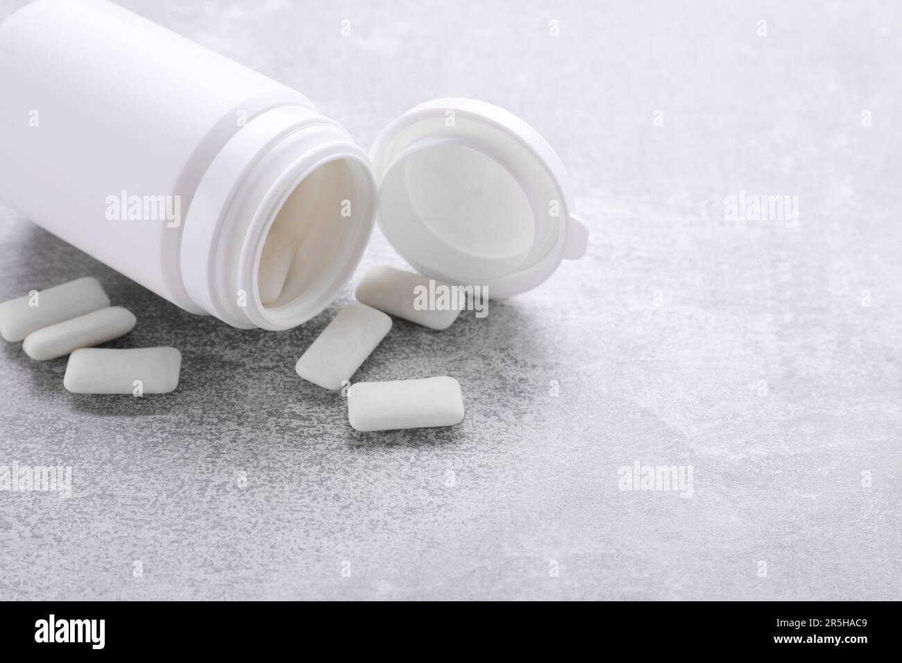 Jar with chewing gums on light grey table Stock Photo Alamy