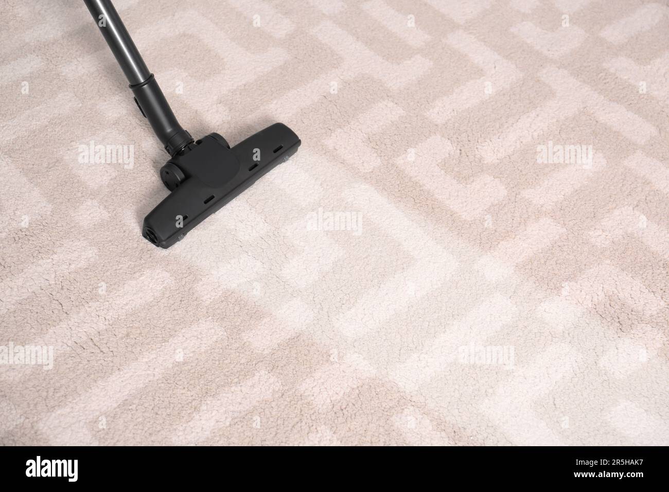 Vacuuming carpet. Clean area after using device, closeup Stock Photo