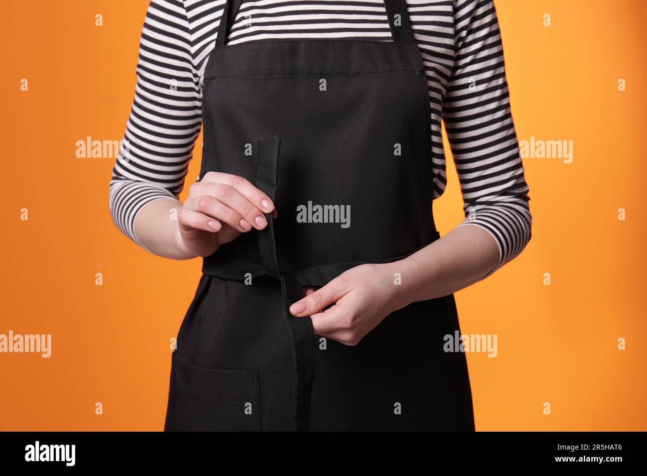 Closeup woman tying apron hi-res stock photography and images - Alamy