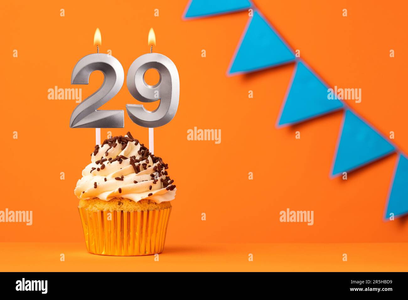 Candle number 29 - Cake birthday in orange background Stock Photo