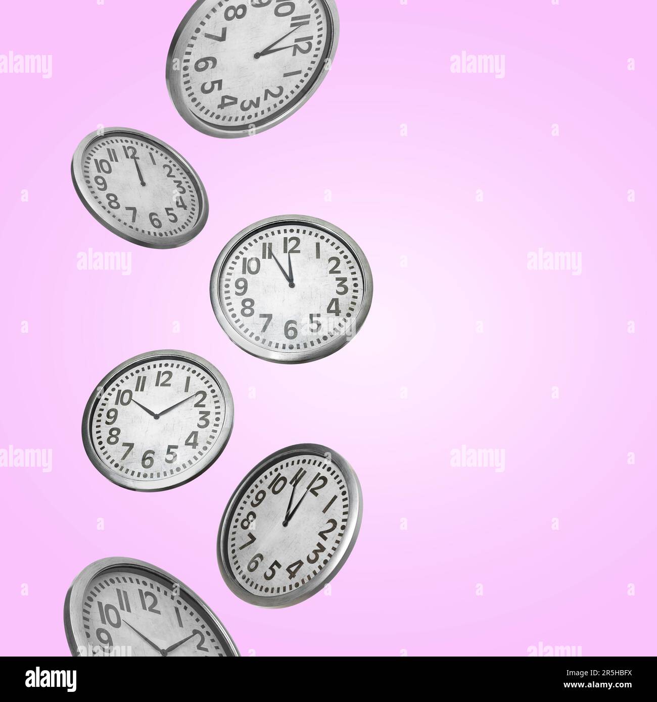 Many clocks falling on pink background. Space for text Stock Photo Alamy