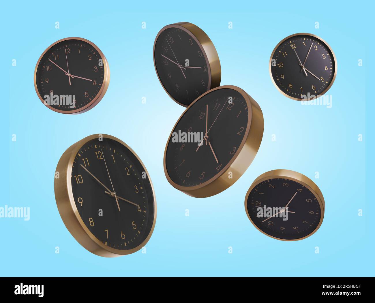 Many clocks falling on light blue background Stock Photo Alamy