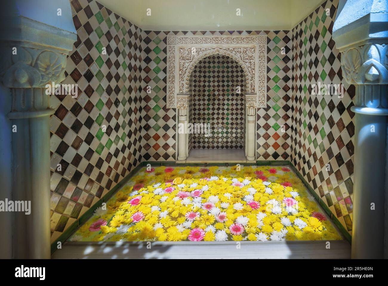Carved Fountain with flowers at Casa Andalusi (House of Andalusia) - Cordoba, Andalusia, Spain Stock Photo