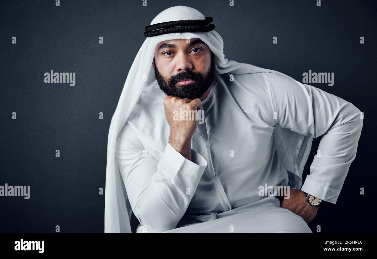 You must understand your weakness to overcome it. Studio shot of a young man dressed in Islamic traditional clothing posing against a dark background. Stock Photo