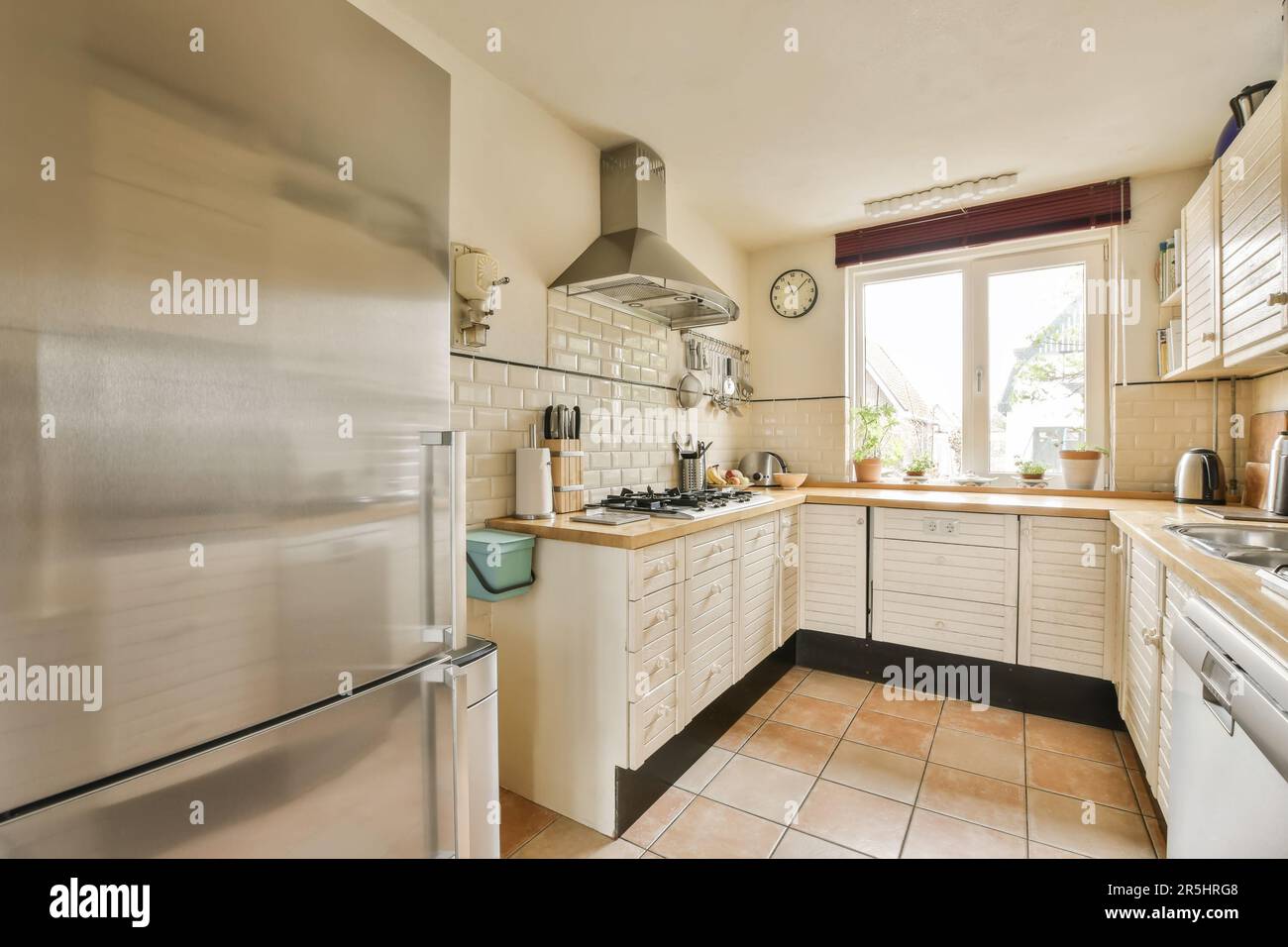 a kitchen with an oven, sink and dishwasher on the floor in front of the refrigerator freezer Stock Photo