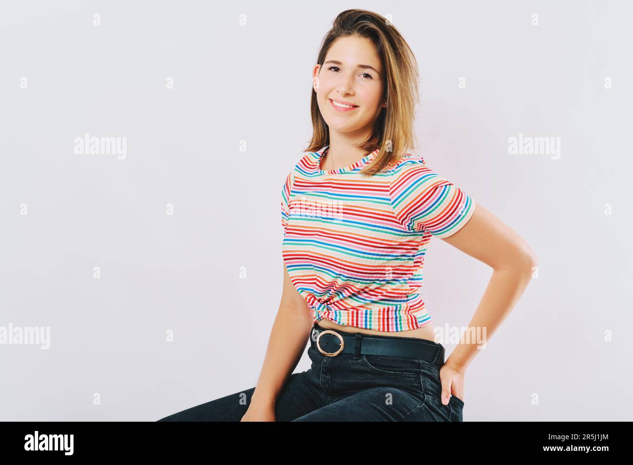 Studio portrait of young happy model, wearing rainnbow t-shirt Stock Photo