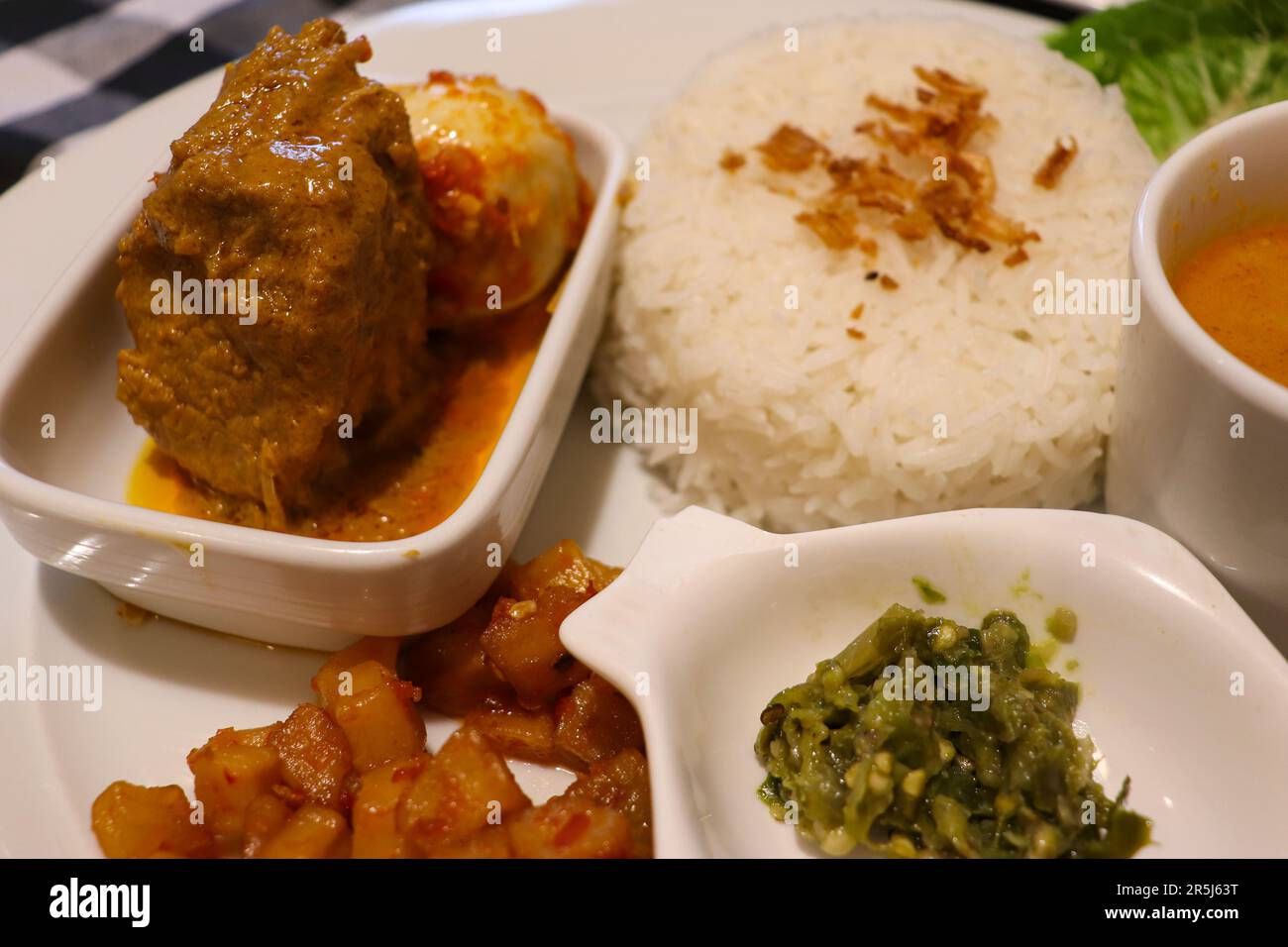 A Complete Dish of Padangnese Food with Rendang, Spicy Potato, Rice