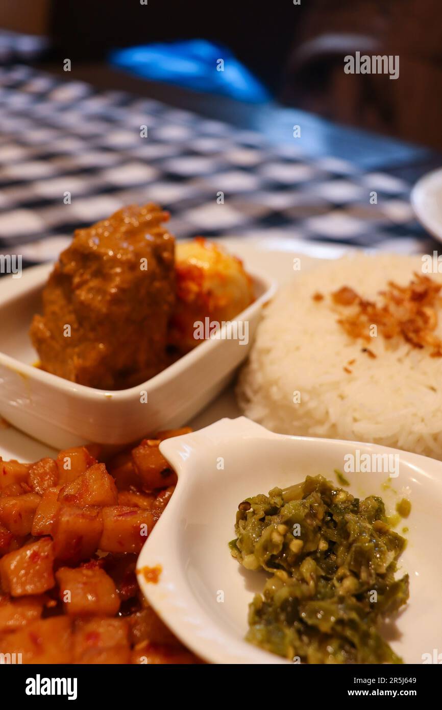 A Complete Dish of Padangnese Food with Rendang, Spicy Potato, Rice