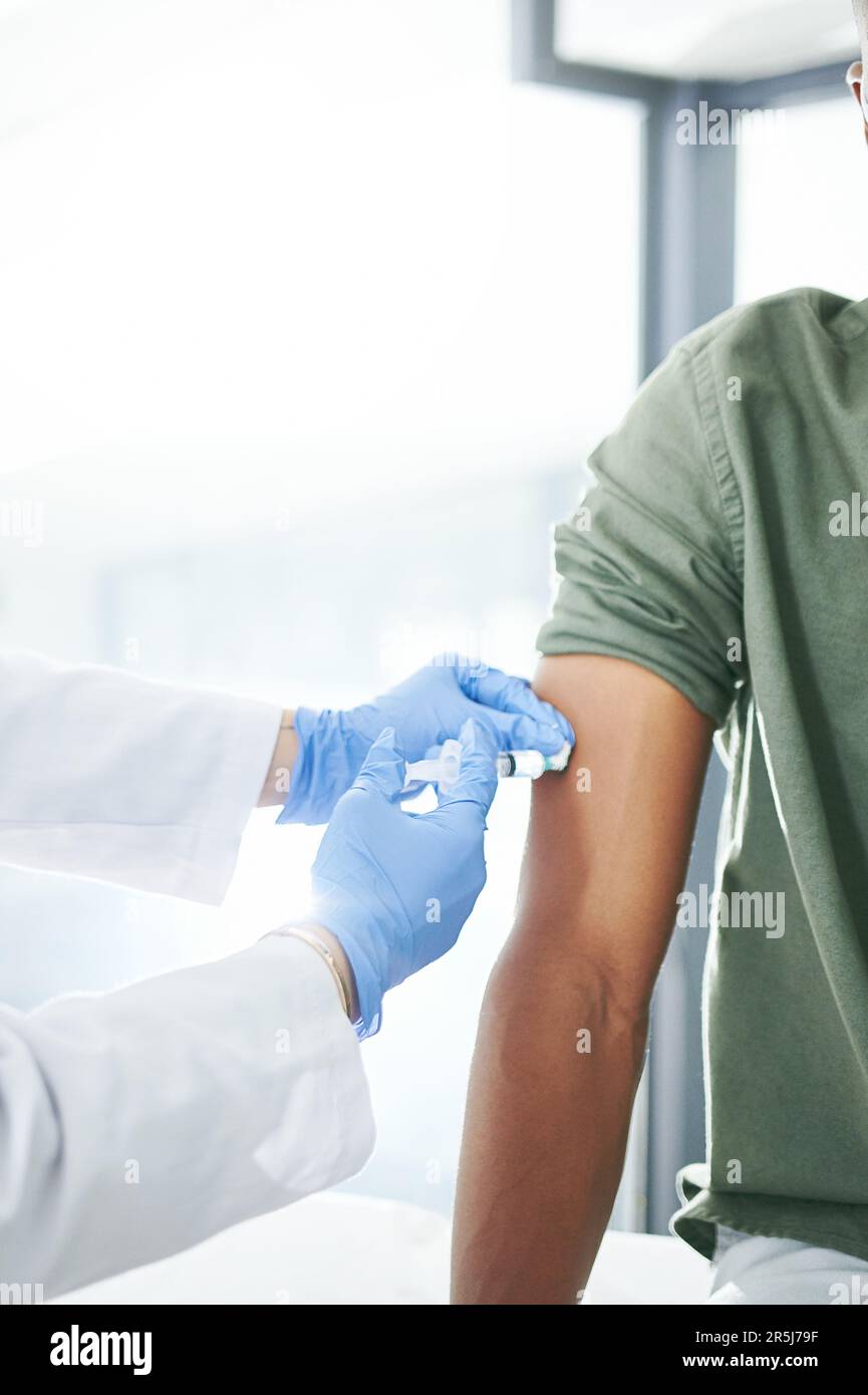 This will protect you. an unrecognizable doctor giving a patient an ...