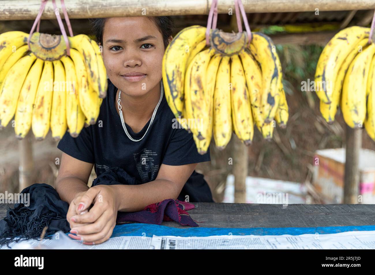 Local Khasi girl selling bananas fruit at the street stand near