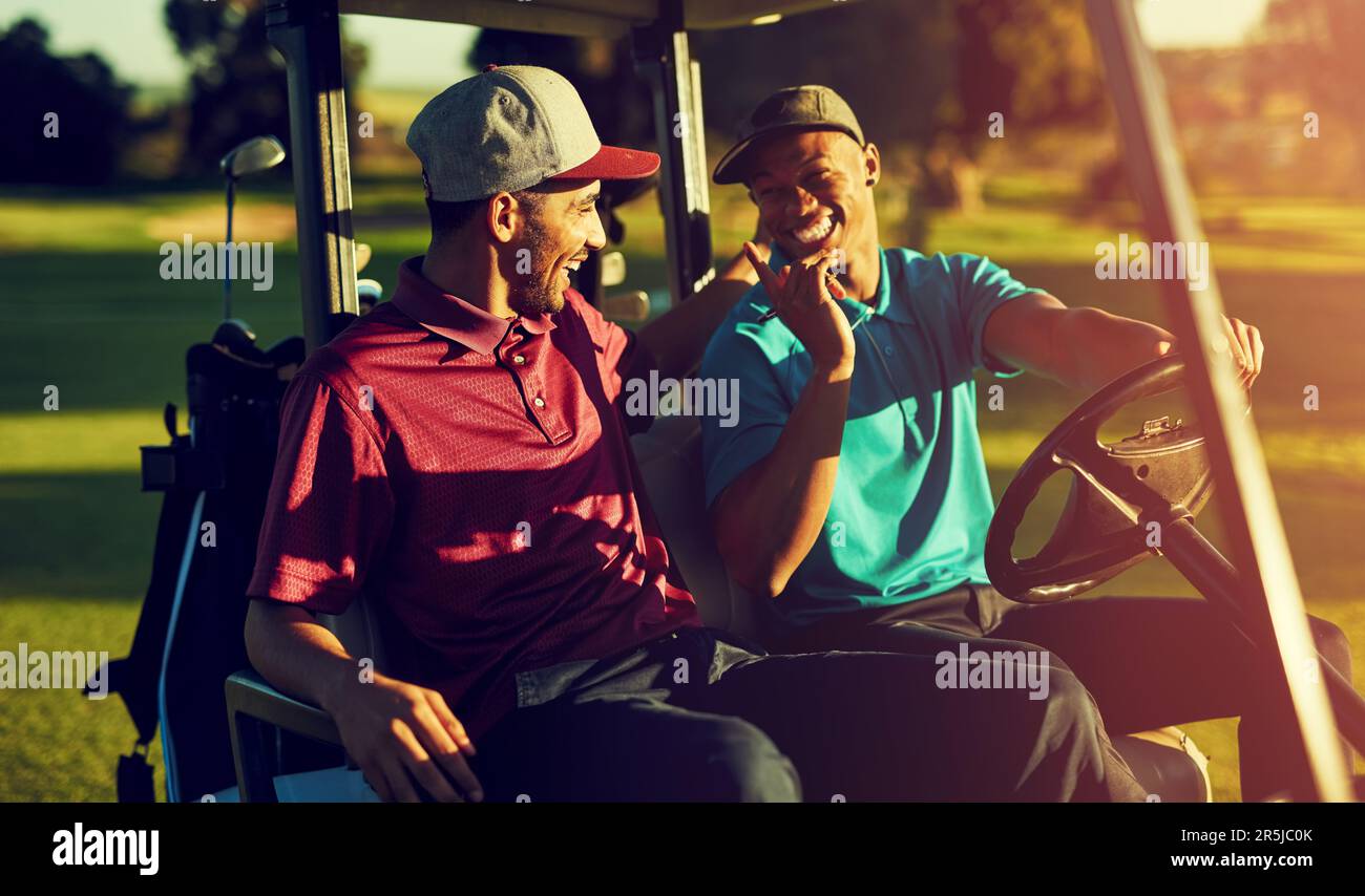 Bring on the Par-Tee. two golfers riding in a cart on a golf course. Stock Photo