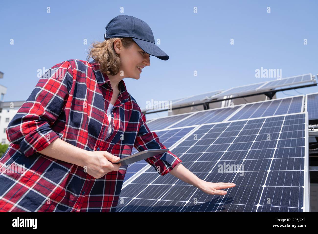 Tablet Using Solar Panel Engineer touching solar panels hi-res stock photography and images - Alamy