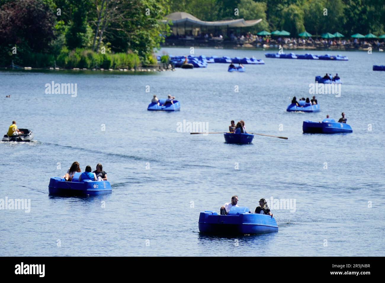 People ride pedalo and rowing boats in the hot weather on the