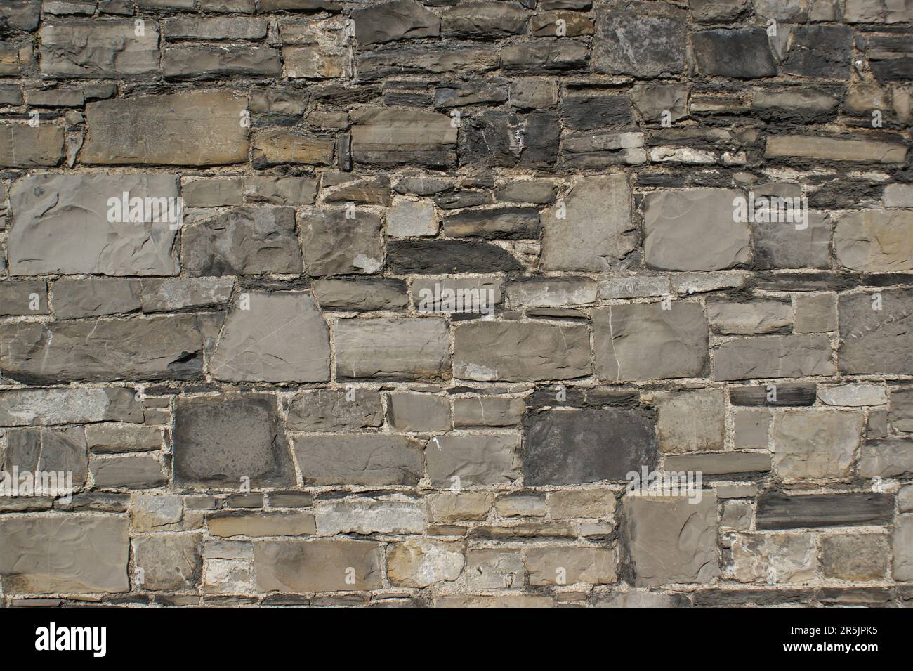 Decorative wall made of natural stones. Background, wall fragment. Stock Photo