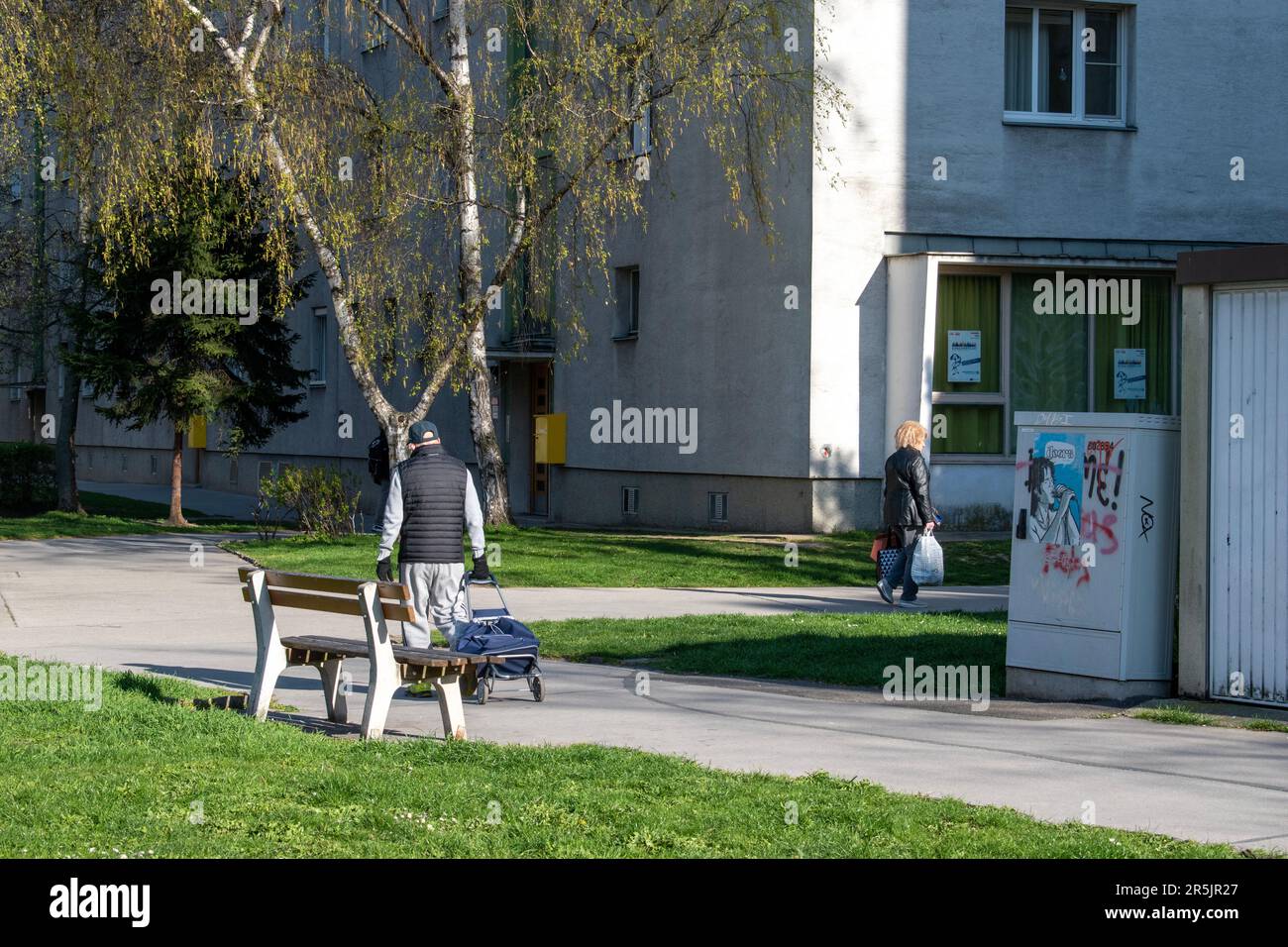vienna, austria. April 5, 2023 a european pathway pedestrians engaging in daily park life Stock Photo