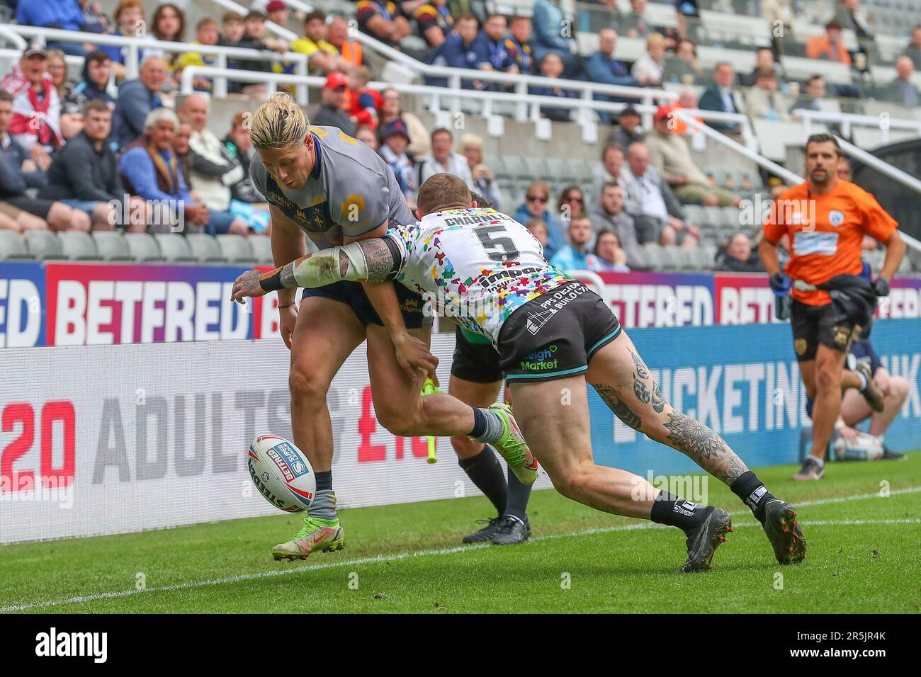 Tom Lineham #5 of Wakefield Trinity is tackled by Josh Charnley #5 of Leigh Leopards during the Magic Weekend match Wakefield Trinity vs Leigh Leopards at St. James's Park, Newcastle, United Kingdom, 4th June 2023  (Photo by Gareth Evans/News Images) Stock Photo