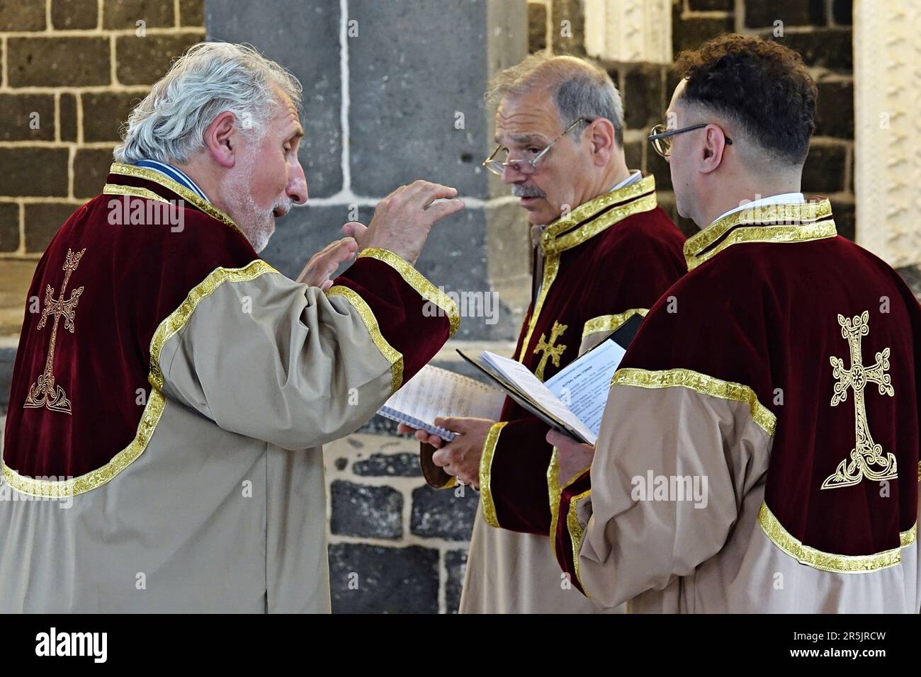 Subordinate Deacon Jan Acemoglu (L) and his two friends are seen reciting hymns during the ritual at Diyarbak?r Surp Hovsep Church. At the Surp Hovsep Armenian Catholic Church, which was heavily damaged in clashes between armed Kurdish PKK militants and Turkish security forces in the center of Diyarbakir in 2015 and repaired as a result of a 4-year restoration, the second ritual in the last 100 years after the first ritual in 2021. Very few Armenians who came from Istanbul and lived in Diyarbakir attended the ceremony. The ritual was led by Senior Priest Abraham Firat and Subordinate Deacon Ja Stock Photo